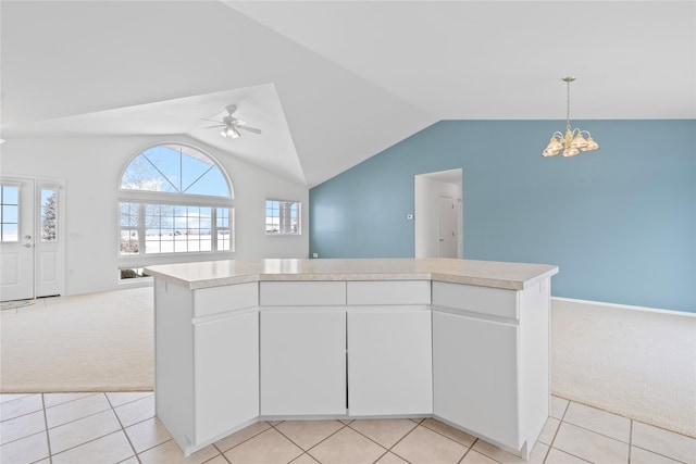 kitchen with white cabinetry, light colored carpet, a center island, and hanging light fixtures