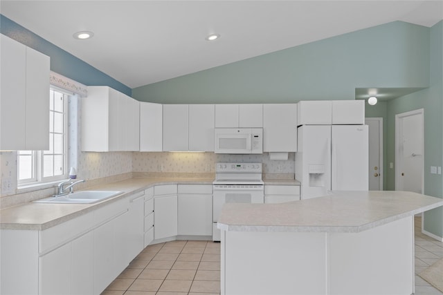 kitchen featuring white appliances, light tile patterned floors, sink, and white cabinets