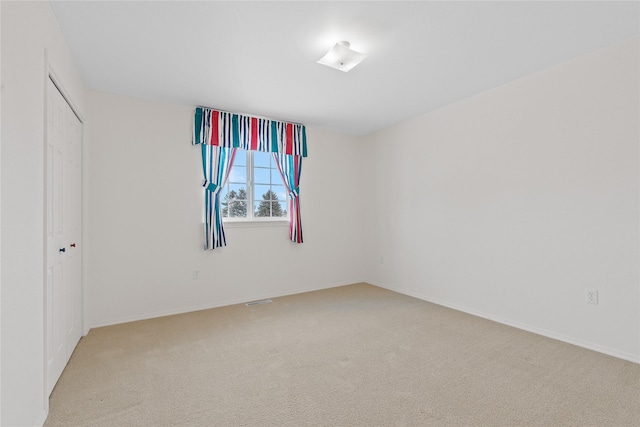 spare room with light carpet