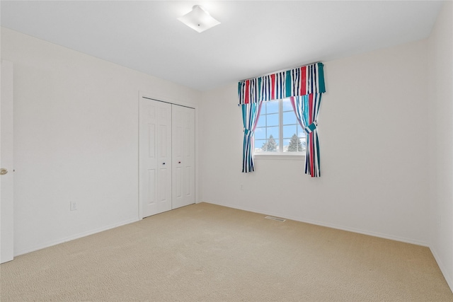 unfurnished bedroom with carpet floors and a closet