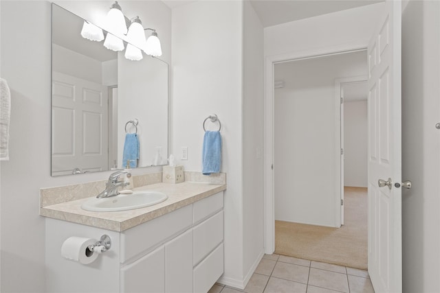 bathroom with tile patterned floors, vanity, and a notable chandelier