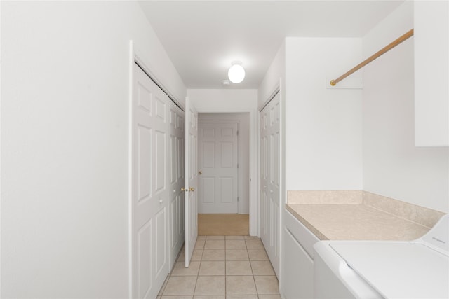 laundry area with light tile patterned flooring