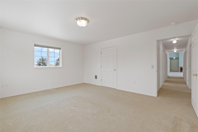 empty room featuring light carpet