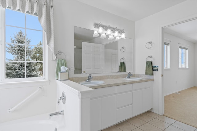 bathroom with tile patterned flooring, vanity, and a tub to relax in