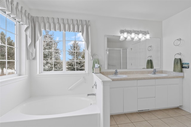 bathroom with vanity, a wealth of natural light, tile patterned floors, and plus walk in shower