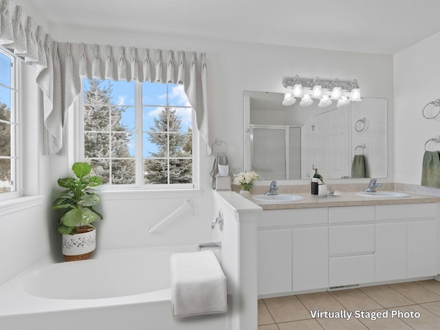 bathroom with tile patterned floors, independent shower and bath, and vanity