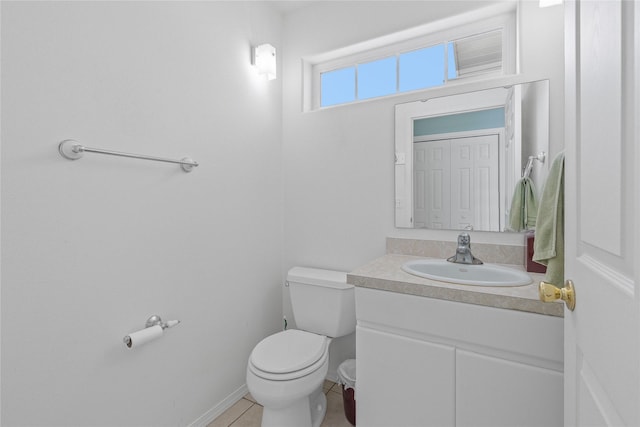 bathroom featuring vanity, tile patterned floors, and toilet