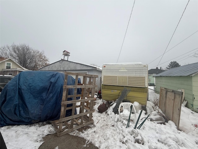 snow covered patio with a grill