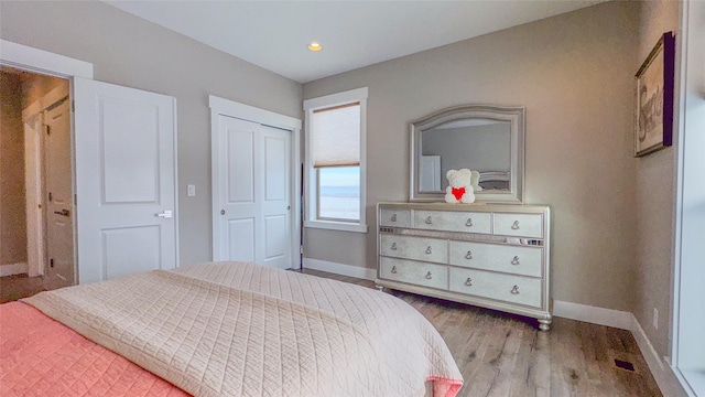 bedroom featuring a closet and light hardwood / wood-style flooring