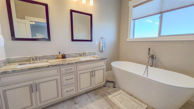 bathroom featuring vanity and a tub