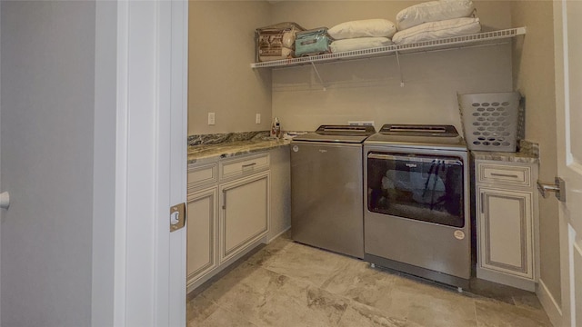 laundry room featuring cabinets and washing machine and clothes dryer