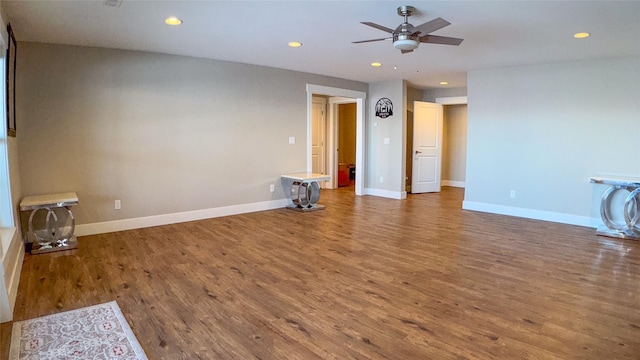 empty room with hardwood / wood-style flooring and ceiling fan