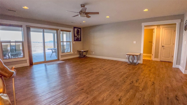 unfurnished living room with hardwood / wood-style flooring and ceiling fan