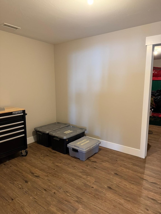 bedroom with dark hardwood / wood-style flooring