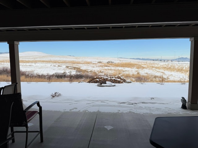 snowy yard featuring a mountain view