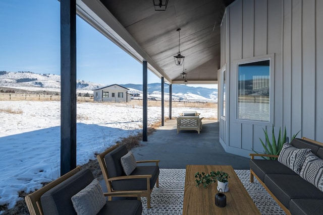 2986 Sunset Ranch Ln, Stevensville, MT 59870 - snow covered patio with an outdoor living space and a mountain view