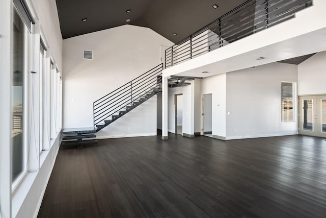 2986 Sunset Ranch Ln, Stevensville, MT 59870 - unfurnished living room with dark hardwood / wood-style flooring, high vaulted ceiling, and french doors