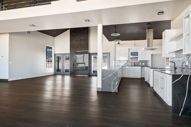 2986 Sunset Ranch Ln, Stevensville, MT 59870 - kitchen featuring sink, white cabinetry, backsplash, high vaulted ceiling, and range hood
