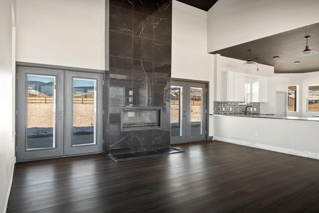 2986 Sunset Ranch Ln, Stevensville, MT 59870 - unfurnished living room with dark hardwood / wood-style floors, french doors, and a high ceiling