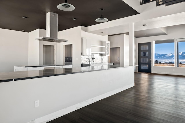 2986 Sunset Ranch Ln, Stevensville, MT 59870 - kitchen featuring sink, dark wood-type flooring, backsplash, white cabinets, and island exhaust hood