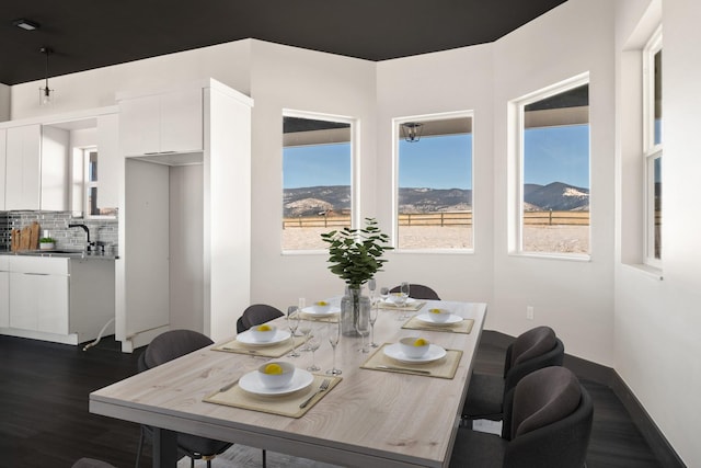 2986 Sunset Ranch Ln, Stevensville, MT 59870 - dining space featuring sink, dark wood-type flooring, and a mountain view