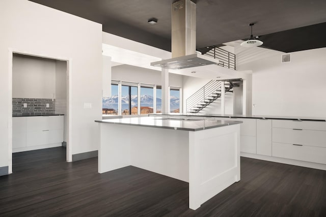 2986 Sunset Ranch Ln, Stevensville, MT 59870 - kitchen featuring white cabinetry, dark hardwood / wood-style floors, a center island, and island exhaust hood