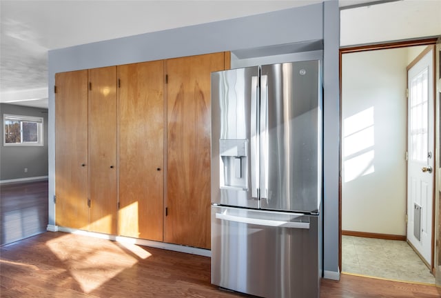 kitchen with stainless steel refrigerator with ice dispenser and dark hardwood / wood-style floors