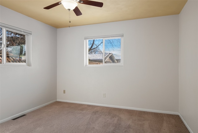 unfurnished room with ceiling fan and light colored carpet