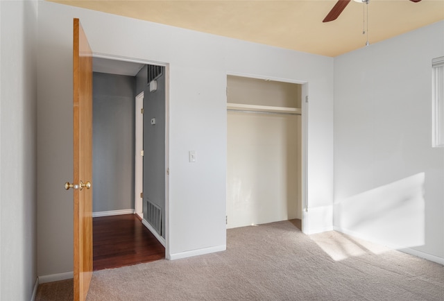 unfurnished bedroom featuring carpet floors, ceiling fan, and a closet