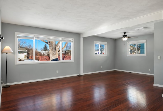 spare room with ceiling fan, a textured ceiling, and dark hardwood / wood-style flooring