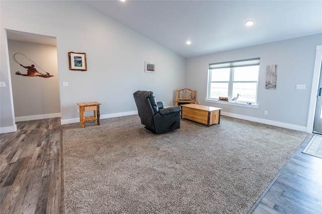 living area featuring hardwood / wood-style flooring and vaulted ceiling