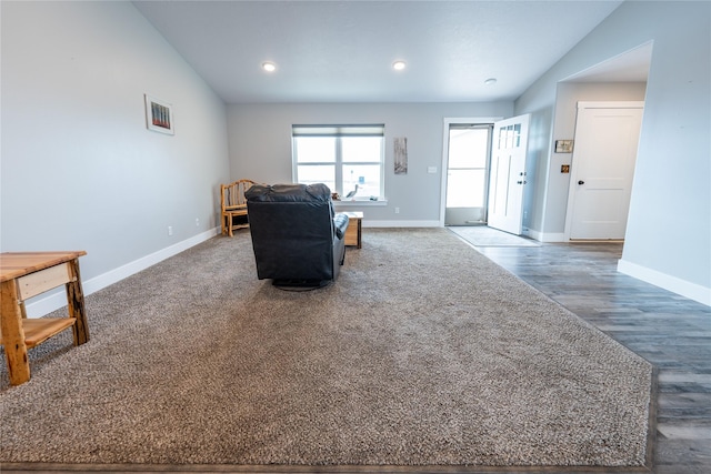 living room featuring hardwood / wood-style flooring and vaulted ceiling