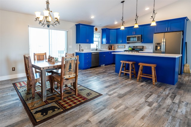 dining space with sink, a notable chandelier, and dark wood-type flooring