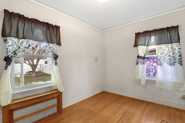 unfurnished room featuring crown molding and hardwood / wood-style floors