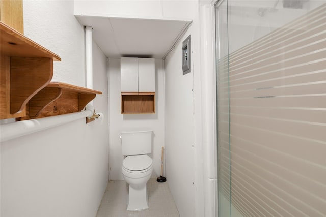 bathroom with toilet and a shower with door