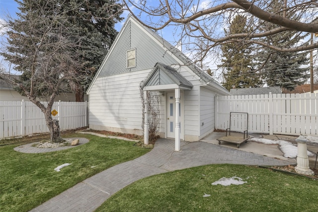 view of front of home with a front yard and a patio