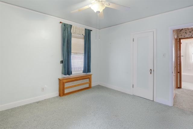 carpeted empty room with a wealth of natural light and ceiling fan