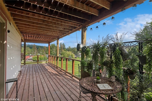 wooden deck featuring a lawn