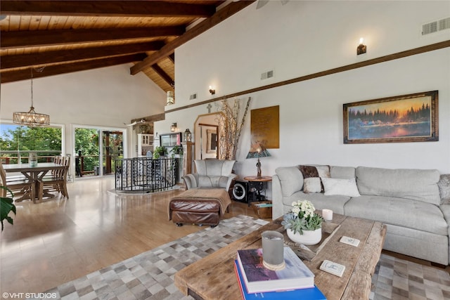 living room with a chandelier, high vaulted ceiling, wooden ceiling, hardwood / wood-style flooring, and beam ceiling