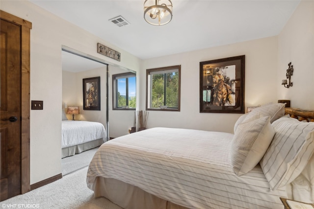 bedroom with light colored carpet and a closet