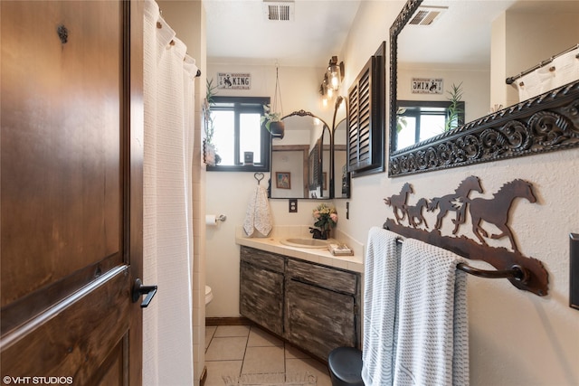 bathroom featuring tile patterned floors, vanity, and toilet