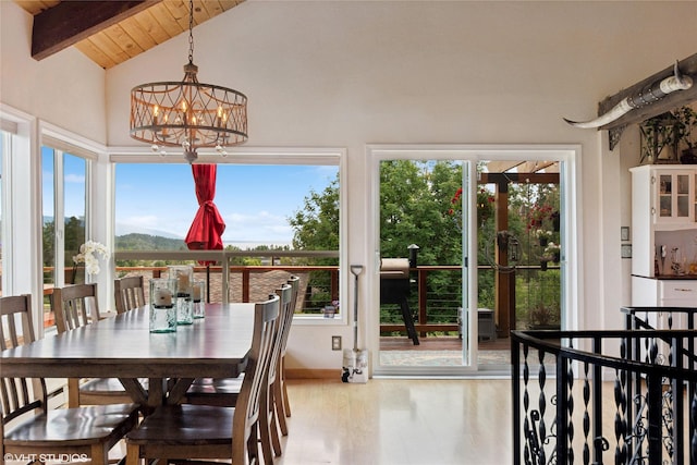 sunroom with vaulted ceiling with beams, a notable chandelier, and wood ceiling