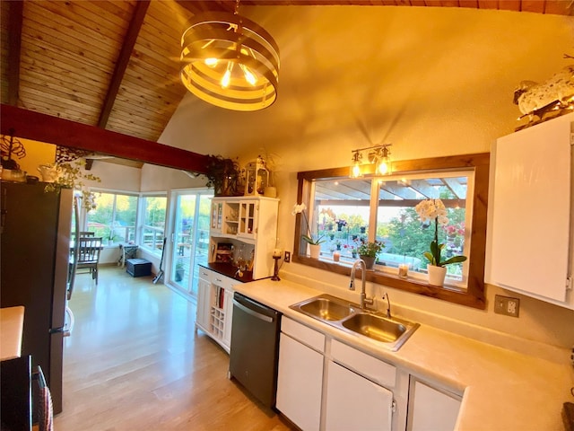 kitchen featuring white cabinetry, dishwasher, sink, and stainless steel fridge