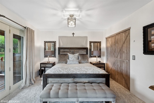 bedroom featuring a barn door, light colored carpet, access to exterior, and french doors