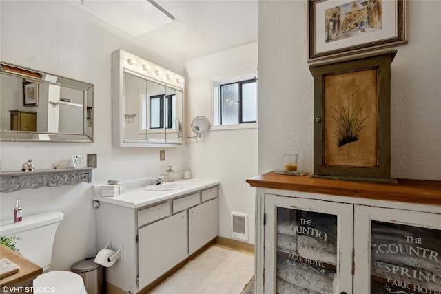 bathroom featuring vanity and toilet