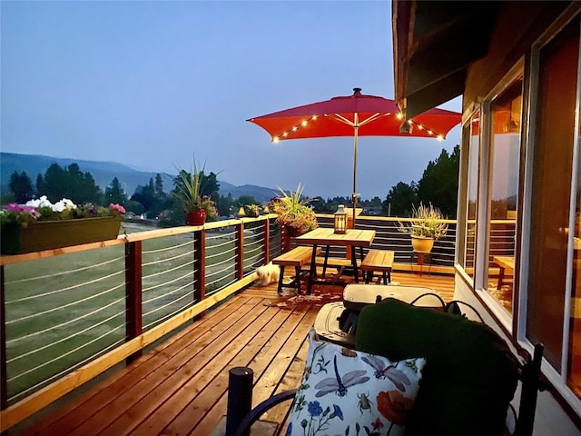 wooden deck with a mountain view