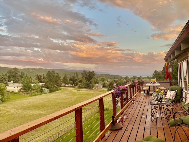 deck at dusk with a lawn