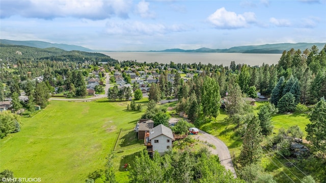 drone / aerial view featuring a water and mountain view