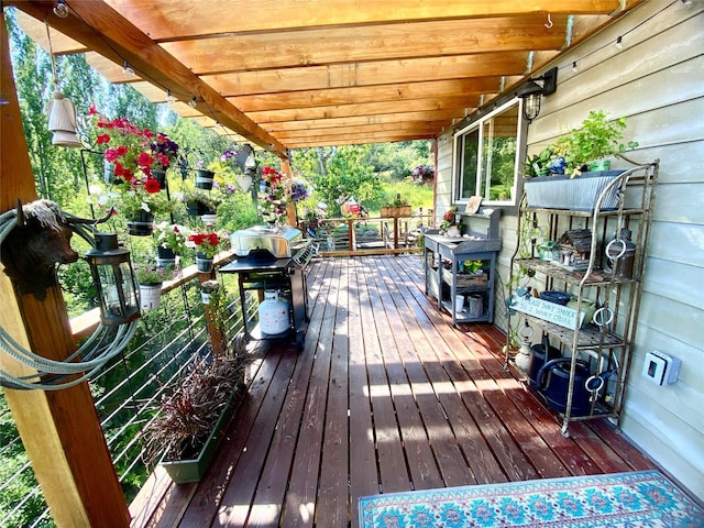 wooden deck featuring a grill