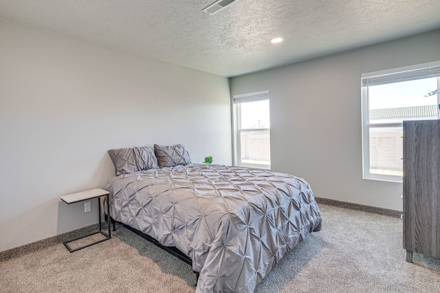 carpeted bedroom with a textured ceiling